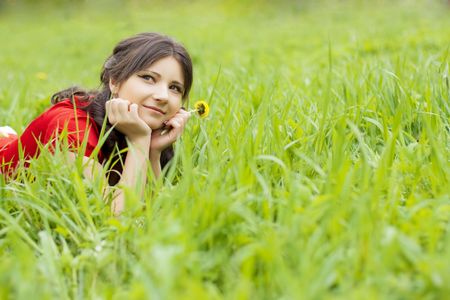Picture of beautiful girl lying on the grass in the parkの写真素材