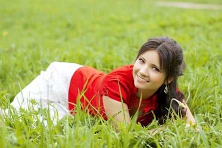 Picture of beautiful girl lying on the grass in the parkの写真素材