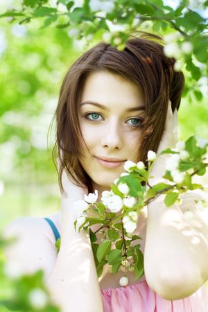 The image of the beautiful girl in the garden among the blooming treesの写真素材