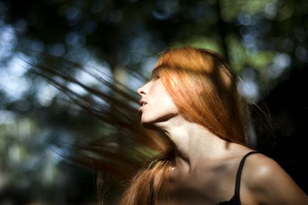 Abstract photo of a girl with developing hair in an outdoor