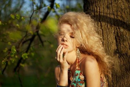 The image of a beautiful girl in the park at sunsetの写真素材