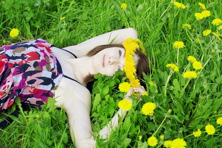 The image of a beautiful girl on a background of flowering flowersの写真素材