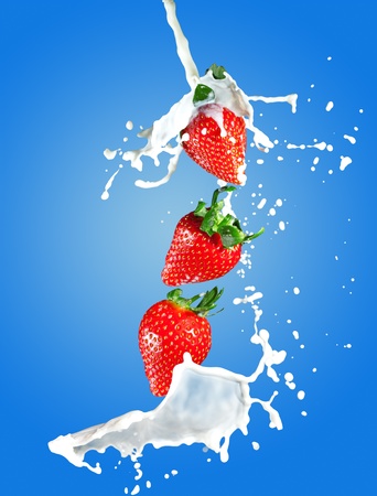 Image of juicy strawberries in milk splashesの写真素材