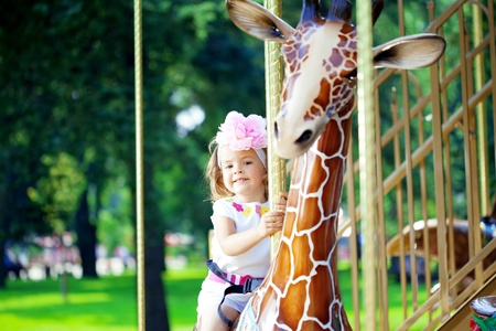 The image of a girl riding on a carouselの写真素材