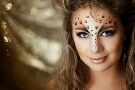 The image of a beautiful girl with an unusual make-up as a leopardの写真素材