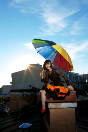 The image of a bright girl on the roofの写真素材