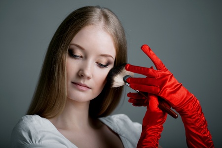 Image of girl in gloves with the professional makeup brush in her hands.の写真素材