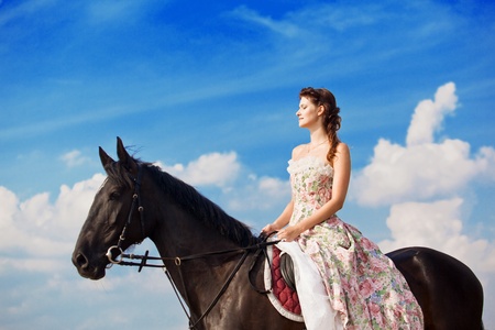 Image of a woman on a horse by the seaの写真素材