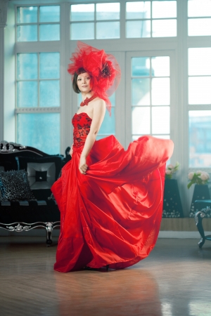 Woman in red at the luxurious interiorの写真素材