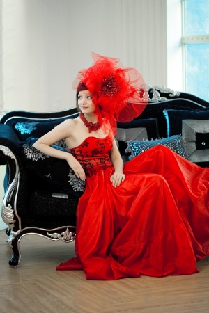 Woman in red at the luxurious interiorの写真素材