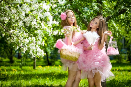 Twin girls in pink doll styleの写真素材