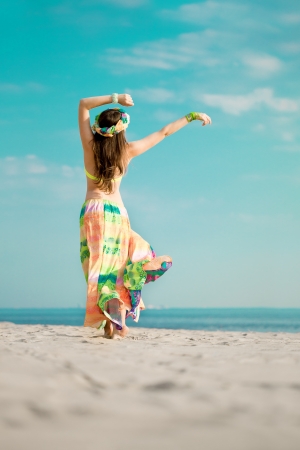 Luxurious beautiful fashionable woman on the beach at sunの写真素材