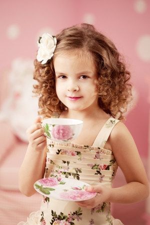 Little cute and sweet girl with teaの写真素材