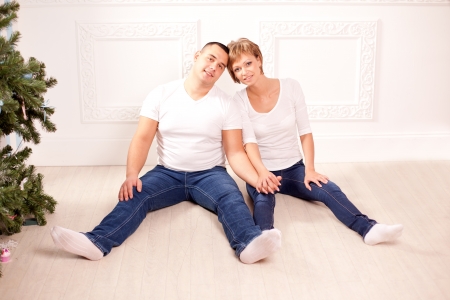 Cute couple in love hugs at home の写真素材