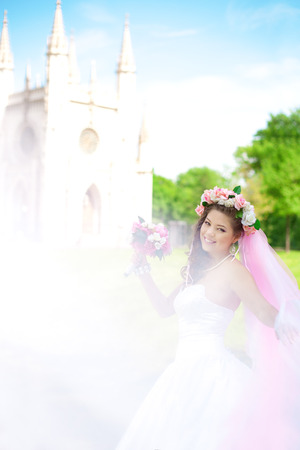 Beautiful young bride in a wreath of flowers on her headの写真素材