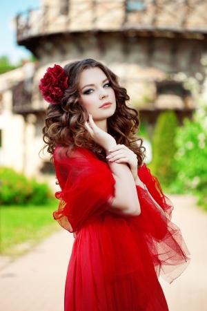 Beautiful woman in a bright red dress of the millの写真素材