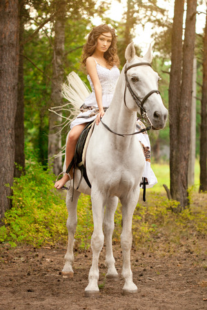 Beautiful woman on a horse. Horseback rider, woman riding horseの写真素材