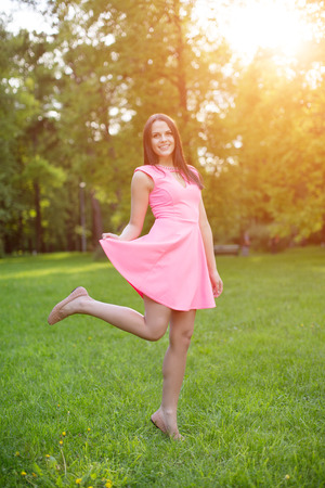 Young hipster model woman Casual Girl in field in Sunset in spring, summer landscape background Springtime Summertime. Allergic to pollen of flowers Allergy Backlit Sun Light Autumn Glow Sun Sunshineの写真素材