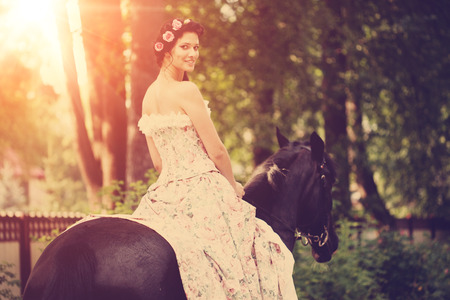 Beautiful woman and a dark horseの写真素材