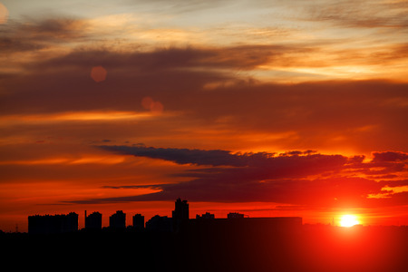 Sunrise in city landscape. Urban sunset. Rays of the sun above the town. Air photography. Dawn of a new dayの写真素材