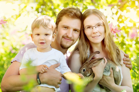 Happy family on a background of the summer landscape. Summer scene about mother, father and son. Summertime party, fun on holidayの写真素材