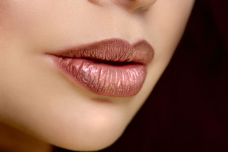 Red woman lips close up. Beautiful model girl with lipstick, manicure with nail polish Products Treatmentの写真素材