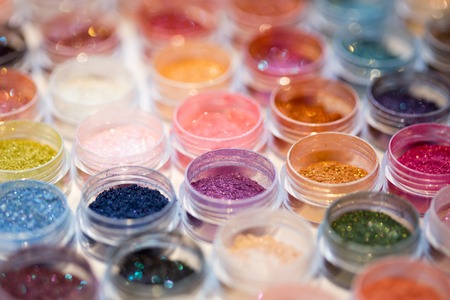 Cosmetics. Pigments for make-up, eyes, lips, face and body. Brilliant radiant, scattered multicolored powders.の写真素材
