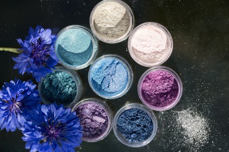 Cosmetics. Pigments for make-up, eyes, lips, face and body. Brilliant radiant, scattered multicolored powders.の写真素材