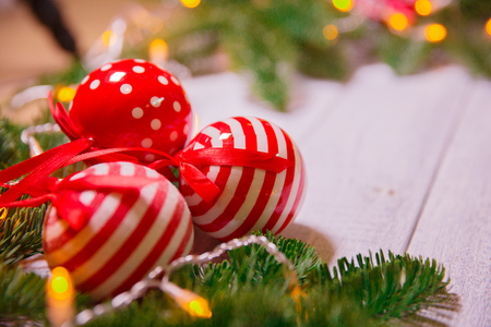 Christmas card. Background on a theme of New Year's  party. Decorated fir-tree with gifts and candles on the background of colorful festive lights. A magical evening.の写真素材