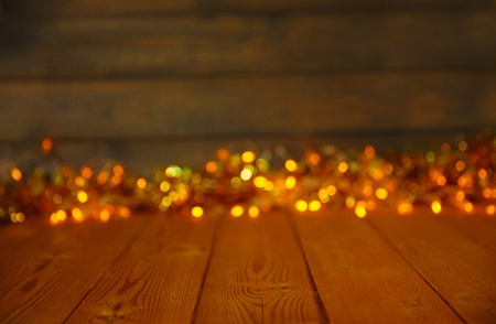 Wooden background with bright lights with a free space for text or product demonstrationの写真素材