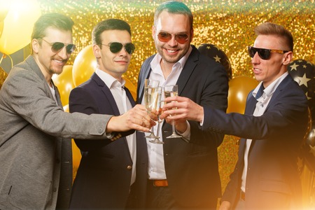 Party people dancing in club. Men celebrate a holiday, a birthday or a new year.の写真素材