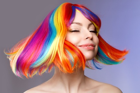 Woman hair as color splash. Rainbow up do short haircut. Beautiful young girl model with glowing  healthy skin.の写真素材