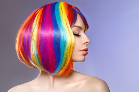 Woman hair as color splash. Rainbow up do short haircut. Beautiful young girl model with glowing  healthy skin.の写真素材