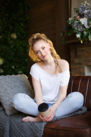 Romantic blonde. Young beautiful cute woman. Beauty girl with long shiny hair, glowing skin and voluminous haircutの写真素材