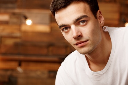 Portrait of a man on a wooden backgroundの写真素材