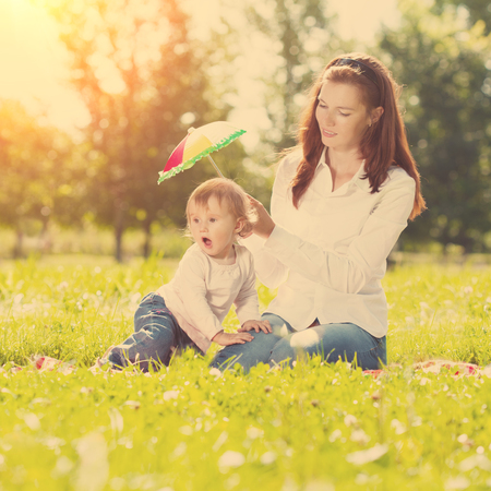 Beautiful Mom and baby outdoors. Happy family playing in nature. Mom and baby. Mother and child.の写真素材