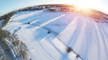 Winter photo with drone. View of the park from above. The quadcopter takes off a sunny winter day. Aerial photographyの写真素材