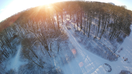 Winter photo with drone. View of the park from above. The quadcopter takes off a sunny winter day. Aerial photographyの写真素材