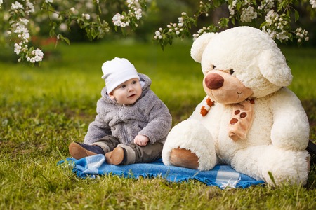 Baby in the park in the rays of sunset. Toddler on the nature outdoors. Backlight. Summertime family  sceneの写真素材