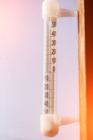 Thermometer with high temperature against the sky. Concept of heat, drought and global warming