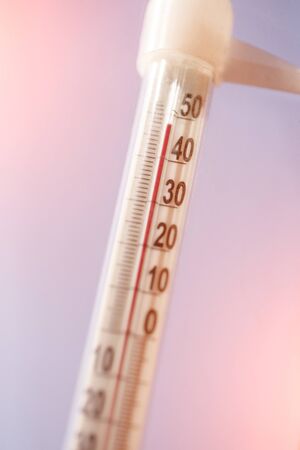 Thermometer with high temperature against the sky. Concept of heat, drought and global warmingの写真素材