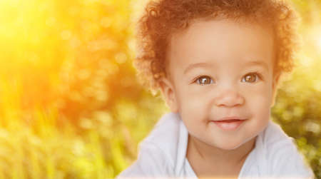 Cute Baby on nature. Happy child in sun backlight. Happy adorable child, happiness and people age concept. Children, infancyの写真素材