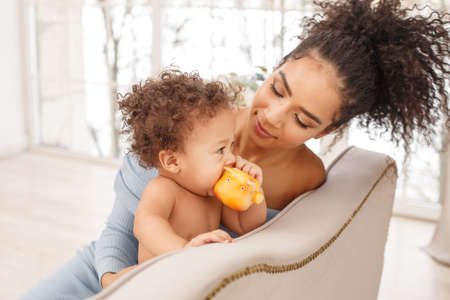 Love of a mother and baby. Son and mom. Family in the house. Lifestyleの写真素材