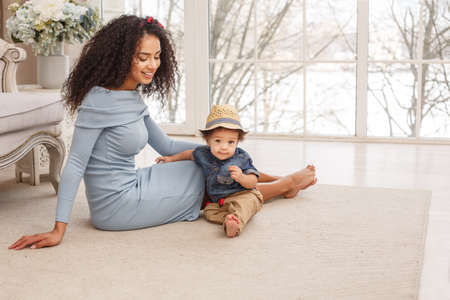 Love of a mother and baby. Son and mom. Family in the house. Lifestyleの写真素材