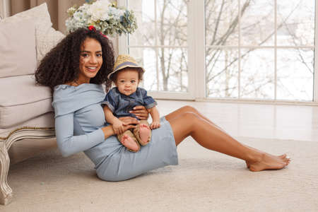 Love of a mother and baby. Son and mom. Family in the house. Lifestyleの写真素材