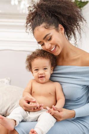 Love of a mother and baby. Son and mom. Family in the house. Lifestyleの写真素材