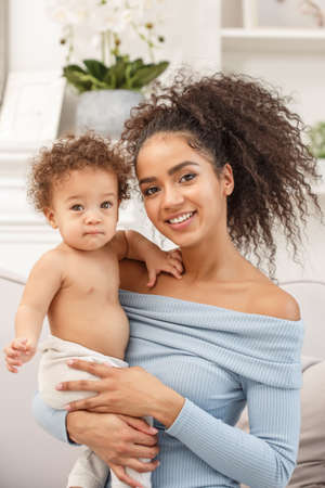 Love of a mother and baby. Son and mom. Family in the house. Lifestyleの写真素材