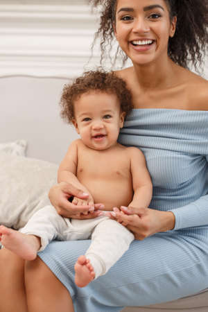 Love of a mother and baby. Son and mom. Family in the house. Lifestyleの写真素材