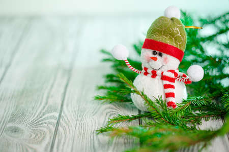 Snowman next to the New Year's tree. Snowman celebrate Christmas. good new year spiritの写真素材
