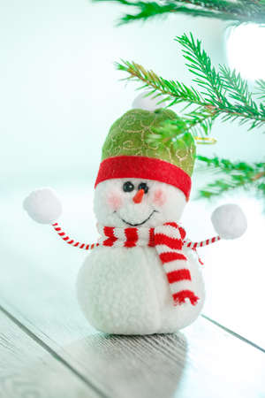 Snowman next to the New Year's tree. Snowman celebrate Christmas. good new year spiritの写真素材